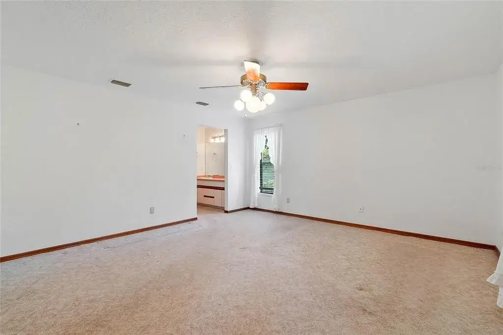 master bedroom view of bathroom vestibule entrance