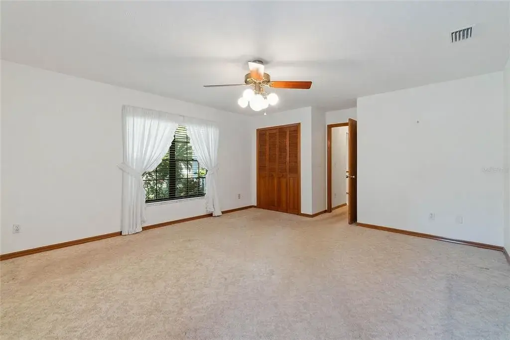 master bedroom view of a reach-in closet