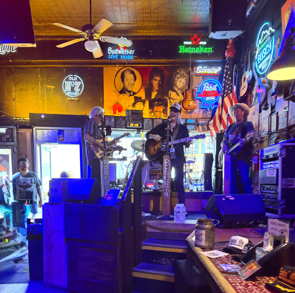 Three-piece band playing on stage at Robert's Western World in Nashville